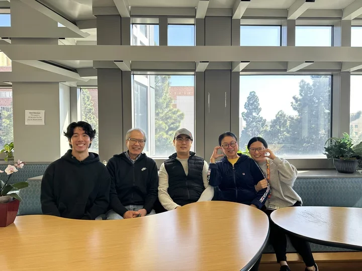 five lab members sitting and posing for a picture